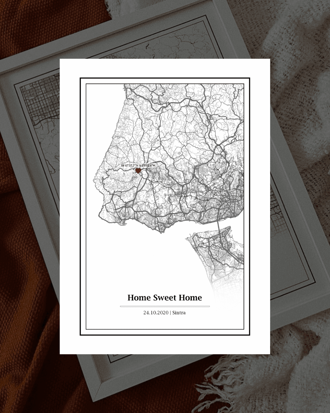 Mapa monocromático com ponto vermelho e texto 'Home Sweet Home' sobre cobertores texturizados